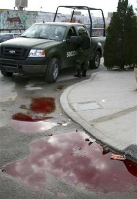 Pool of blood outside the house where the gunmen struck