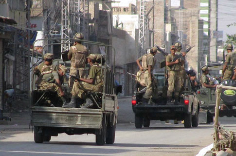 Pakistan's army troops prepare to leave for patrolling during the curfew in Bannu - AP Photo/Ijaz Muhammad