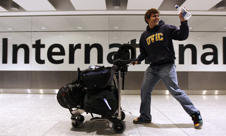 Passenger waves with joy as he finds out his plane will depart. - Photograph: Suzanne Plunkett/Reuters