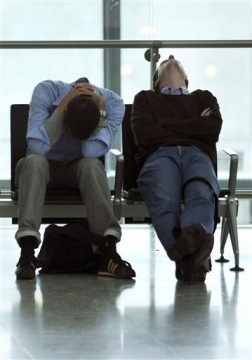 BRITAIN HEATHROW TERMINAL 5 Two travellers in London Heathrow in the departure area with no answers as so many thousands in same position - Photo by : AP Photo/Matt Dunham