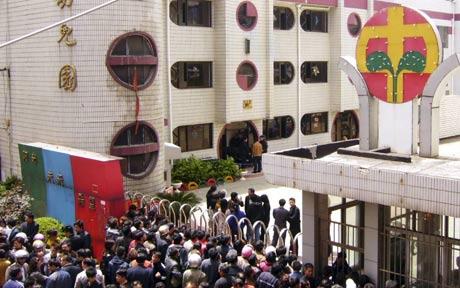 China knife attack - nationalturk Parents gather outside the kindergarten where a knife wielding crazed man attacked and injured 32 people including 29 children - Photo by - Reuters