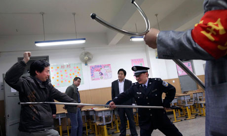 Police demonstrates how to fend of attackers with a restraint stick - Photo by : Ap
