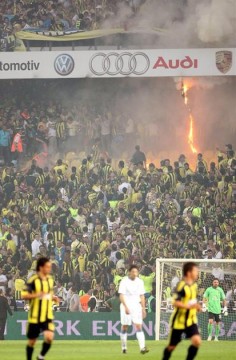 Fans start fires in sections of the Fenerbahce Sukru Saracoglu Stadium.