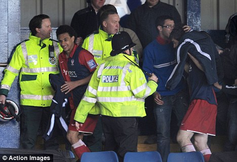 York players stone by Luton fans York players shielding themselves from coins,bottles and other debris thrown at them.