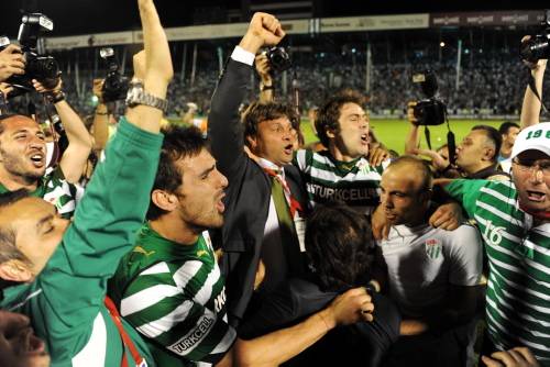 Bursaspor manager, Ertugrul Saglam celebrates the championship received after winning his former club where he served for years as a player and a manager