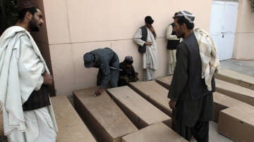 Relatives and loved ones around the coffins of the victims of the deadly Afghanistan wedding blast - Photo by : Alauddin Khan/Associated Press