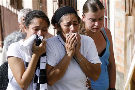 Relatives of one of the miners who was found dead mourning by his body at a make shift morgue near the coal mine in Colombia - Photo by : REUTERS/Fredy Amariles