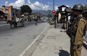 Paramilitary officers standing guard in the streets of Kashmir