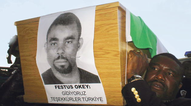 Festus Okey in the coffin, under his picture : We depart, thank you Turkey