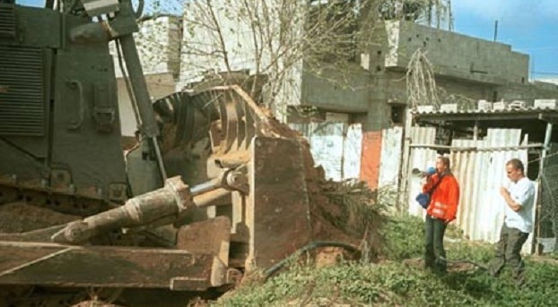 Rachel Corrie in front of an Israeli army bulldozer at Rafah, 16 March 2003 Rachel Corrie in front of an Israeli army bulldozer at Rafah, 16 March 2003