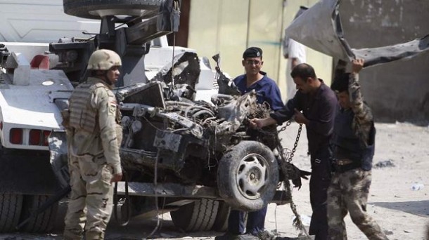 Iraqi security personnel inspect the site of a car bomb attack in Basra, 420 km (261 miles) southeast of Baghdad Iraqi security personnel inspect the site of a car bomb attack in Basra, 420 km (261 miles) southeast of Baghdad