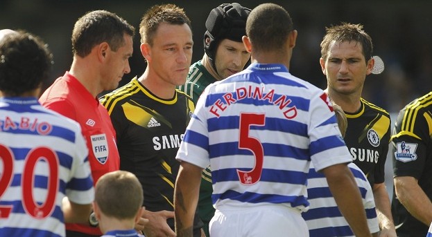 Queens Park Rangers' Anton Ferdinand ignores the hand of Chelsea's John Terry, third left, during a pre-match handshakes before the start of their English Premier League soccer match at Loftus Road stadium, London, Saturday, Sept. 15, 2012. Chelsea's captain John Terry was acquitted in July of racially abusing Anton Ferdinand in last year's corresponding match. 