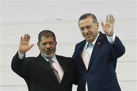 Turkey's PM and leader of ruling AKP Erdogan and Egypt's President Mursi greeting the audience during the AKP congress 