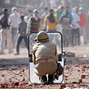 Stone Pelting in Indian Administered Kashmir Policeman ducks while youth pelt stones on him during clashes in Indian administered Kashmir. File Pic