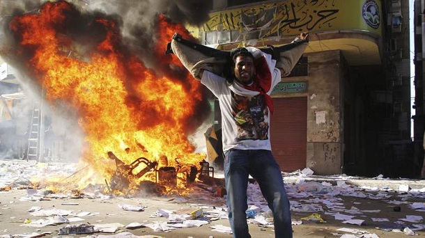 A protester cheers as items ransacked from an office of the Muslim Brotherhood's Freedom and Justice Party burn in Alexandria November 23, 2012. Egyptian President Mohamed Mursi's decree that put his decisions above legal challenge until a new parliament was elected caused fury amongst his opponents on Friday who accused him of being the new Hosni Mubarak and hijacking the revolution. Police fired tear gas in a street leading to Cairo's Tahrir Square, heart of the 2011 anti-Mubarak uprising, where thousands demanded Mursi quit and accused him of launching a "coup". There were violent protests in Alexandria, Port Said and Suez. A protester cheers as items ransacked from an office of the Muslim Brotherhood's Freedom and Justice Party burn in Alexandria November 23, 2012. Egyptian President Mohamed Mursi's decree that put his decisions above legal challenge until a new parliament was elected caused fury amongst his opponents on Friday who accused him of being the new Hosni Mubarak and hijacking the revolution. Police fired tear gas in a street leading to Cairo's Tahrir Square, heart of the 2011 anti-Mubarak uprising, where thousands demanded Mursi quit and accused him of launching a "coup". There were violent protests in Alexandria, Port Said and Suez.