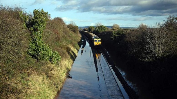TAUNTON, ENGLAND - NOVEMBER 21: A train waits to pass along flooded track close to the village of North Curry on November 21, 2012 near Taunton, England. Heavy rain overnight has brought widespread disruption to many parts of the UK particularly in the Somerset and Wiltshire and weather forecasters have warned of more wet and windy weather to come. TAUNTON, ENGLAND - NOVEMBER 21: A train waits to pass along flooded track close to the village of North Curry on November 21, 2012 near Taunton, England. Heavy rain overnight has brought widespread disruption to many parts of the UK particularly in the Somerset and Wiltshire and weather forecasters have warned of more wet and windy weather to come.