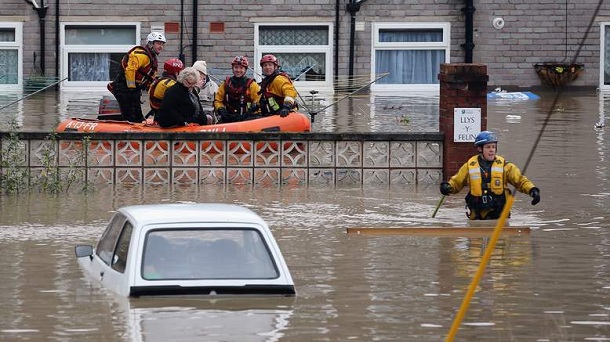 ST ASAPH, UNITED KINGDOM - NOVEMBER 27: An RNLI life boat rescue residents in the flooded streets of St Asaph in North Wales after torrential overnight rain on November 27, 2012 in St Asaph, Wales. Residents in up to 500 homes in St Asaph have been advised to evacuate as flood waters continue to rise and the River Elwy breaks its banks. ST ASAPH, UNITED KINGDOM - NOVEMBER 27: An RNLI life boat rescue residents in the flooded streets of St Asaph in North Wales after torrential overnight rain on November 27, 2012 in St Asaph, Wales. Residents in up to 500 homes in St Asaph have been advised to evacuate as flood waters continue to rise and the River Elwy breaks its banks.