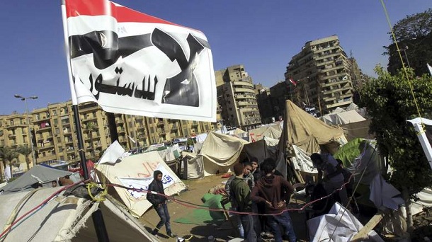 Anti-Mursi protesters sit outside their tents, below a flag that reads, "No, to Constitution" at Tahrir Square in Cairo December 10, 2012. The Egyptian government has given the military the authority to arrest civilians to help safeguard a constitutional referendum Islamist President Mohamed Mursi has planned for Saturday, the official gazette said. Anti-Mursi protesters sit outside their tents, below a flag that reads, "No, to Constitution" at Tahrir Square in Cairo December 10, 2012. The Egyptian government has given the military the authority to arrest civilians to help safeguard a constitutional referendum Islamist President Mohamed Mursi has planned for Saturday, the official gazette said.