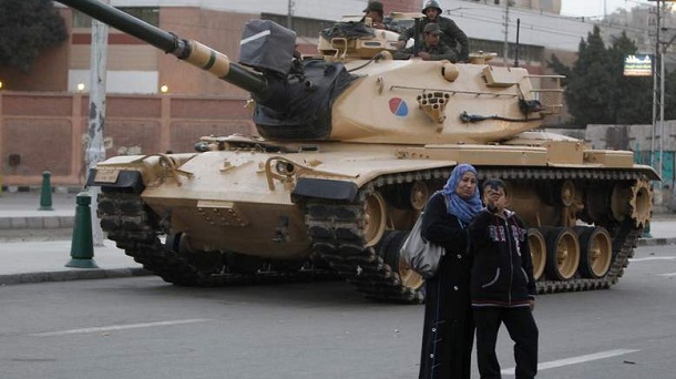 An Egyptian boy and his mother take a photo near an army tank from the republican guard in front of the presidential palace in Cairo December 10, 2012. Egypt's Islamist President Mohamed Mursi has given the army temporary power to arrest civilians during a constitutional referendum he is determined to push through despite the risk of bloodshed between his supporters and opponents accusing him of a power grab. An Egyptian boy and his mother take a photo near an army tank from the republican guard in front of the presidential palace in Cairo December 10, 2012. Egypt's Islamist President Mohamed Mursi has given the army temporary power to arrest civilians during a constitutional referendum he is determined to push through despite the risk of bloodshed between his supporters and opponents accusing him of a power grab.