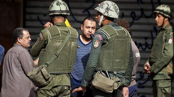 Egyptian army soldiers stand guard as opposition protesters check identification cards at the entrance of the area outside the presidential palace in Cairo where opposition supporters are gathering on December 10, 2012, ahead of expected demonstrations later in the week. President Mohamed Morsi has ordered Egypt's army to "cooperate" with police and given it powers of arrest until the results of a referendum to be held this weekend, Egyptian army soldiers stand guard as opposition protesters check identification cards at the entrance of the area outside the presidential palace in Cairo where opposition supporters are gathering on December 10, 2012, ahead of expected demonstrations later in the week. President Mohamed Morsi has ordered Egypt's army to "cooperate" with police and given it powers of arrest until the results of a referendum to be held this weekend,