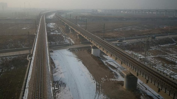 This photo shows a view from the window of a high-speed train during a journey organised for journalists to showcase a newly-built section of track through Hebei province, south of Beijing on December 22, 2012. China was showing off to the media the final link of the world's longest high-speed rail route, set to open on December 26, stretching from Beijing to the southern Chinese city of Guangzhou. Travelling at around 300 kph, trains on the new route are expected to cover the 2,298-kilometre (1,425-mile) journey in a third of the current time from 22 hours to eight. This photo shows a view from the window of a high-speed train during a journey organised for journalists to showcase a newly-built section of track through Hebei province, south of Beijing on December 22, 2012. China was showing off to the media the final link of the world's longest high-speed rail route, set to open on December 26, stretching from Beijing to the southern Chinese city of Guangzhou. Travelling at around 300 kph, trains on the new route are expected to cover the 2,298-kilometre (1,425-mile) journey in a third of the current time from 22 hours to eight.