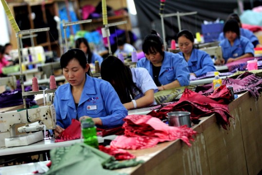 Chinese women working in an umbrella factory. File Pic