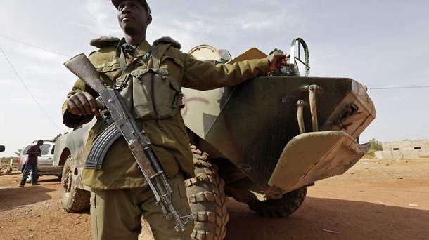 A Malian soldier stands guard near an armoured vehicle in the recently liberated town of Konna January 26, 2013. A Malian soldier stands guard near an armoured vehicle in the recently liberated town of Konna January 26, 2013.