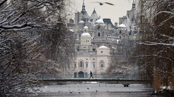 LONDON, UNITED KINGDOM - JANUARY 21: A man walks on The Blue Bridge over the partially frozen lake in St James's Park on January 21, 2013 in London, England. The United Kingdom has suffered a weekend of heavy snowfall with many transport routes affected. LONDON, UNITED KINGDOM - JANUARY 21: A man walks on The Blue Bridge over the partially frozen lake in St James's Park on January 21, 2013 in London, England. The United Kingdom has suffered a weekend of heavy snowfall with many transport routes affected.