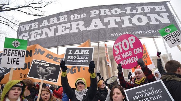 Anti-abortion activists hold placards infront of the US Supreme Court during the annual "March for Life" on January 25, 2013 in Washington, DC. The march coincides with the landmark Roe vs. Wade US Supreme Court decision that legalized access to abortion. Anti-abortion activists hold placards infront of the US Supreme Court during the annual "March for Life" on January 25, 2013 in Washington, DC. The march coincides with the landmark Roe vs. Wade US Supreme Court decision that legalized access to abortion.