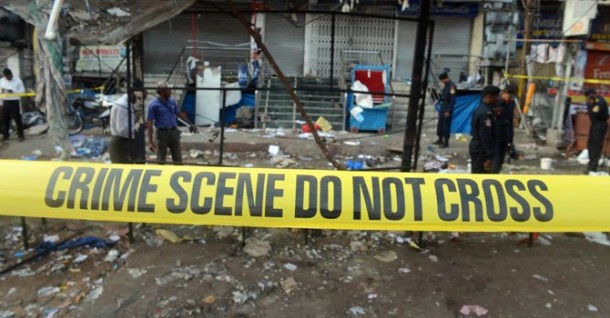 Policemen search for clues at one of the blast sites at Dilsukh Nagar, Hyderabad .