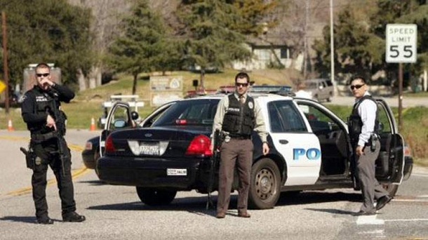 Police stand at a road block at Hwy. 38 and Bryant Street just north of Yucaipa, Calif. as a gunfight between police and fugitive ex-Los Angeles cop Christopher Dorner takes place farther up the highway in the Seven Oaks community, Tuesday, Feb. 12, 2013. Police stand at a road block at Hwy. 38 and Bryant Street just north of Yucaipa, Calif. as a gunfight between police and fugitive ex-Los Angeles cop Christopher Dorner takes place farther up the highway in the Seven Oaks community, Tuesday, Feb. 12, 2013.