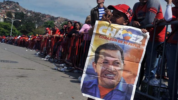 Supporters of the late Venezuelan President Hugo Chavez queue outside the Military Academy chapel waiting to pay last respects to the leader on March 7, 2013 in Caracas. Venezuelans filed past the open casket of late President Hugo Chavez as he lay in state after throngs of weeping loyalists gave the firebrand leftist a rousing farewell on the streets on the eve. Supporters of the late Venezuelan President Hugo Chavez queue outside the Military Academy chapel waiting to pay last respects to the leader on March 7, 2013 in Caracas. Venezuelans filed past the open casket of late President Hugo Chavez as he lay in state after throngs of weeping loyalists gave the firebrand leftist a rousing farewell on the streets on the eve.