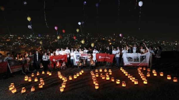 Syrian and local children release balloons and form the word "Syria" with candles during a moment of silence the night before the second anniversary of the start of the Syrian Revolution at the Citadel, an ancient Roman landmark in Amman, March 14, 2013. Syrian and local children release balloons and form the word "Syria" with candles during a moment of silence the night before the second anniversary of the start of the Syrian Revolution at the Citadel, an ancient Roman landmark in Amman, March 14, 2013.