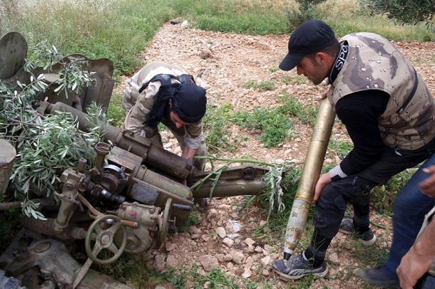 Free Syrian Army fighters load an artillery shell in Aleppo's countryside Free Syrian Army fighters load an artillery shell in Aleppo's countryside
