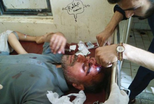 A person injured in bombing being attended by a doctor. 