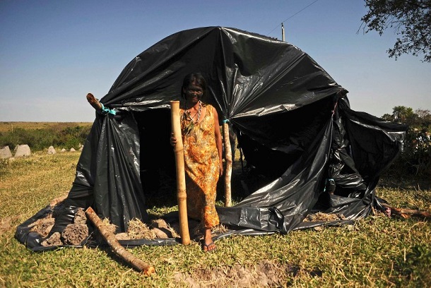 Brazilian Indian of Guarani-Kaiowa tribe stands after group invaded private ranch they consider part of their sacred land in Paranhos Brazilian Indian of Guarani-Kaiowa tribe stands after group invaded private ranch they consider part of their sacred land in Paranhos