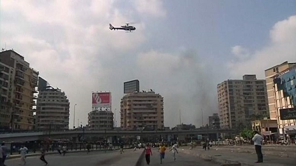 A helicopter hovers over the scene as security forces break up the protest camp at al-Nahda square in Cairo A helicopter hovers over the scene as security forces break up the protest camp at al-Nahda square in Cairo