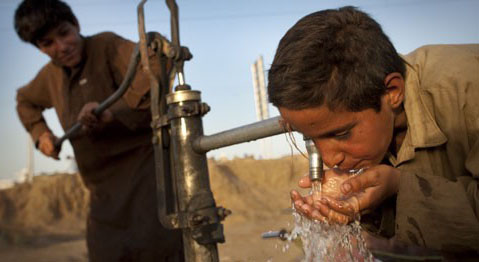 A boy drinks water from a tube well in Pakistan. File Pic