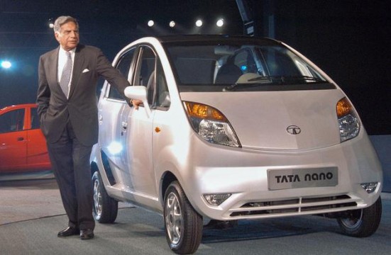 Rata Tata poses for picture near minicar Nano. File Pic