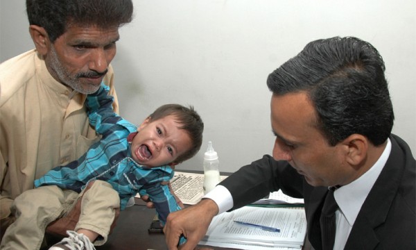 9-month old baby Musa being finger printed in court. File pic