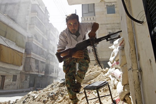 Syrian rebel runs for cover during fighting with regime forces. File Pic