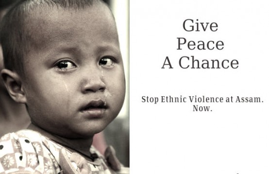 A child holds a placard demanding end to violence in India’s Assam State.