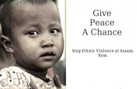 A child holds a placard demanding end to violence in India’s Assam State.  