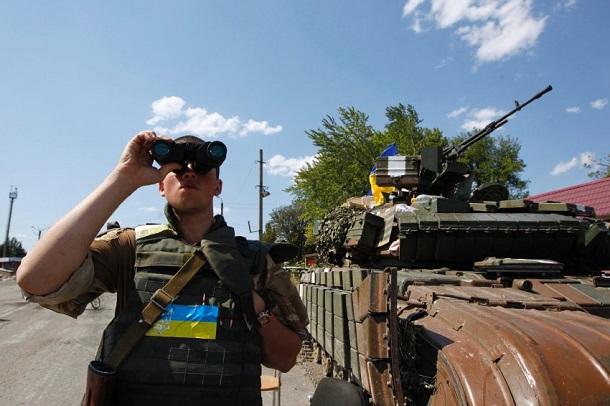 An Ukrainian army serviceman looks through binoculars as he guards a checkpoint in Debaltseve, in Donetsk region An Ukrainian army serviceman looks through binoculars as he guards a checkpoint in Debaltseve, in Donetsk region