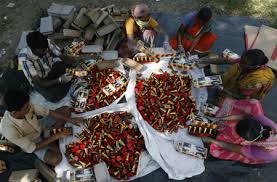 Men preparing firecrackers in India. File Pic