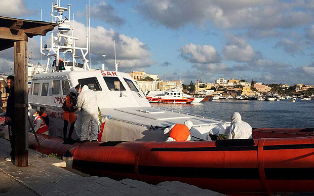 An Italian Coast Guard boat arrives with the surviving migrants on Lampedusa Photo: (EPA)