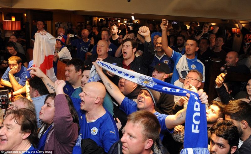 Leicester City players and fans celebrate winning the Premier League