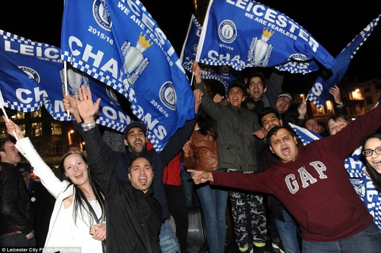 Leicester City players and fans celebrate winning the Premier League