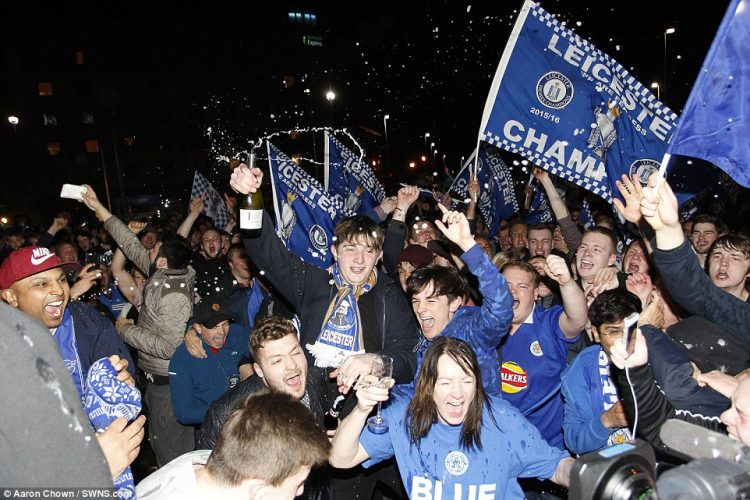 Leicester City players and fans celebrate winning the Premier League