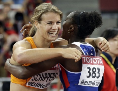 Dafne Schippers of the Netherlands, left, celebrates with Britain's Dina Asher-Smith after winning the gold medal in the women's 200m final at the World Athletics Championships at the Bird's Nest stadium in Beijing, Friday, Aug. 28, 2015. (AP Photo/Lee Jin-man)